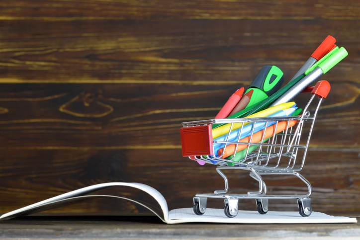 Back to school. School supplies in shopping cart