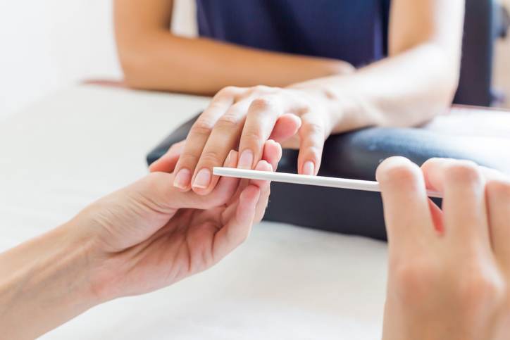 Manicurist performing a professional manicure